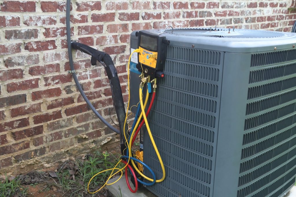 Here's Why Your Air Conditioner Isn't Working 3 An air conditioning unit with a device on it to test if the A/C unit is working.